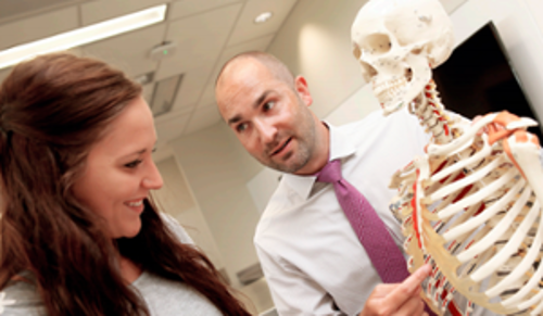 Instructor showing a skeleton to a student